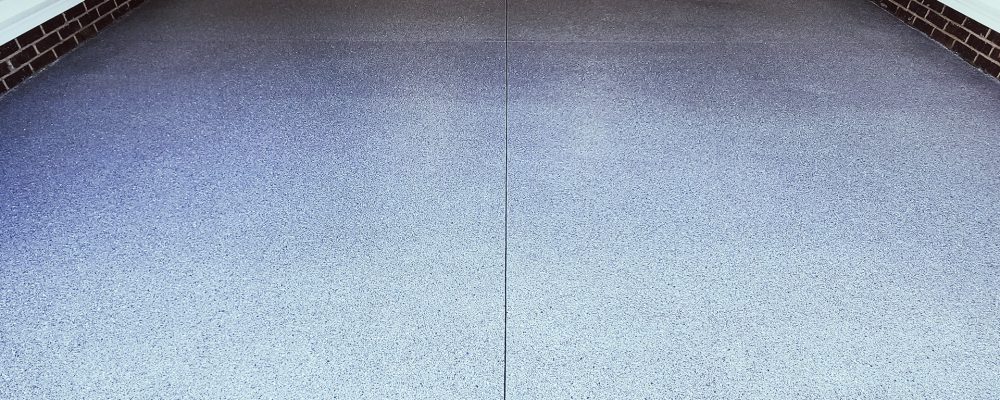 garage floor with stained concrete in gray and black specks